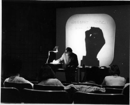 A liberal arts professor writing on an overhead projector. Photo taken around 1980. (Image courtesy of DePaul University Special Collections and Archives)